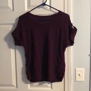 Burgundy woman’s shirt sleeve sweater.